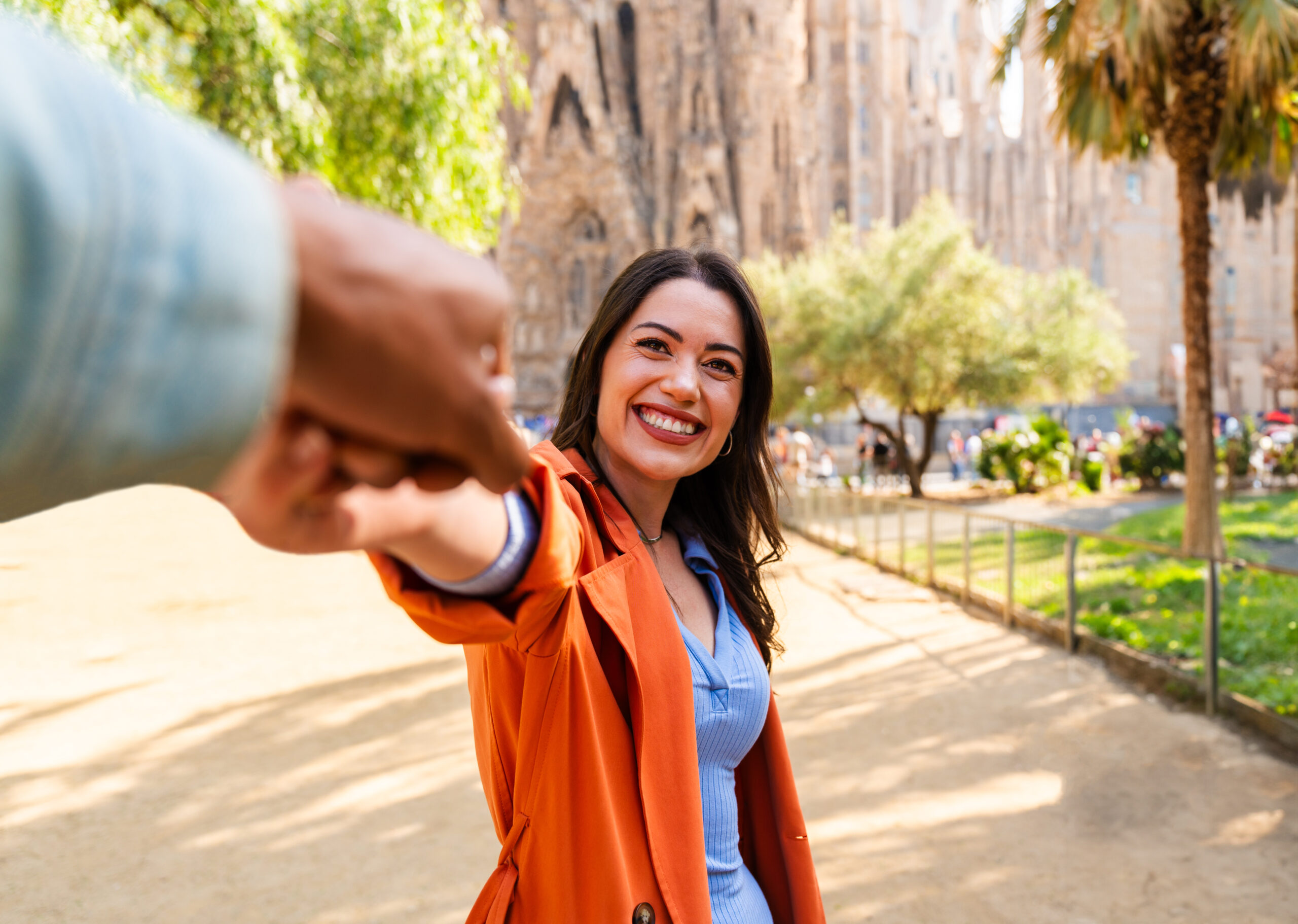 Multiracial beautiful happy couple of lovers dating at Sagrada Familia, Barcelona - Multiethnic tourists travelling in Europe and visiting a city in Spain, concepts about tourism and people lifestyle