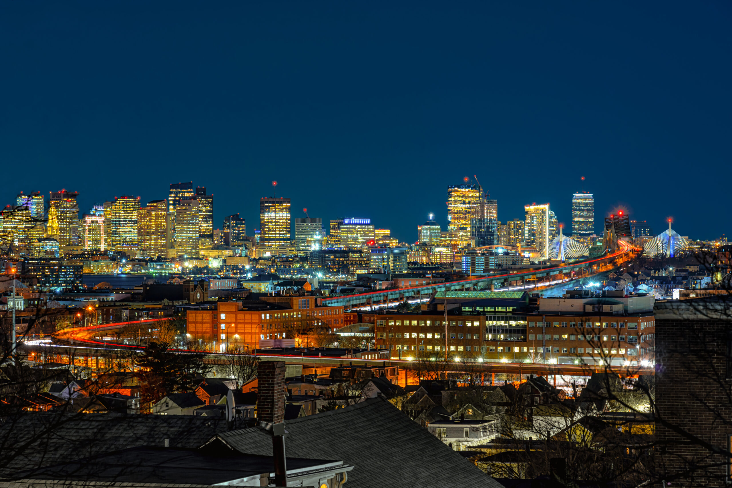 Scene of Boston skyline which can see Zakim Bridge and Tobin Bridge with express way over the Boston Cityscape at twilight time, USA downtown skyline, Architecture and building with tourist concept